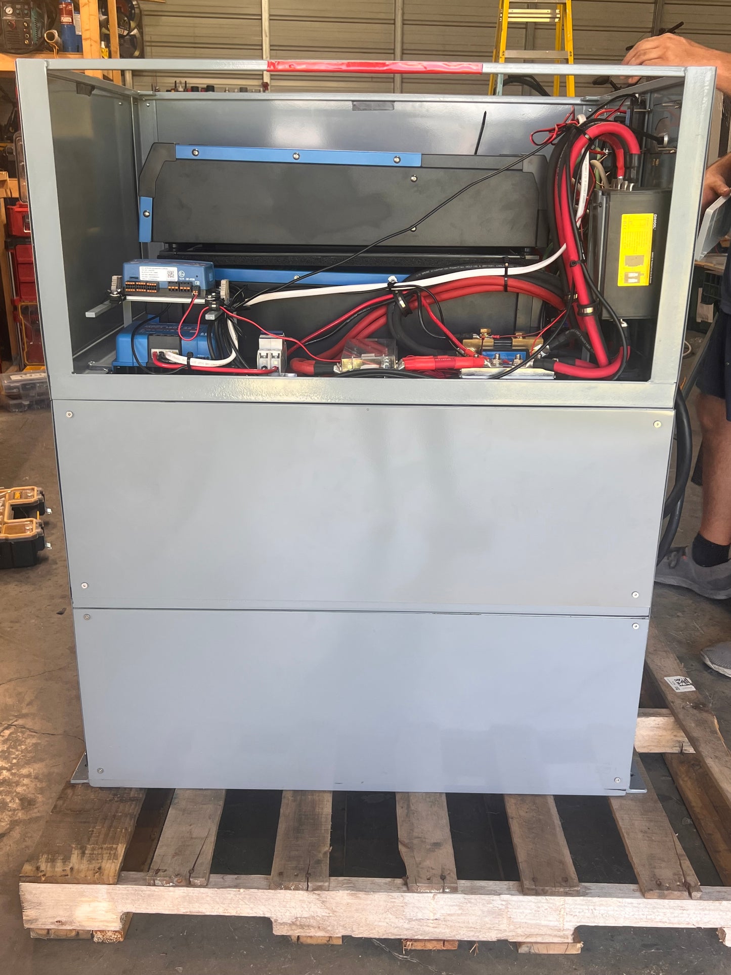 Metal cabinet with electrical wiring on a wooden pallet